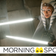 Rosario Dawson wields two white-bladed lightsabers and wears a grey cloak as Clone Wars hero Ahsoka Tano in The Mandalorian.